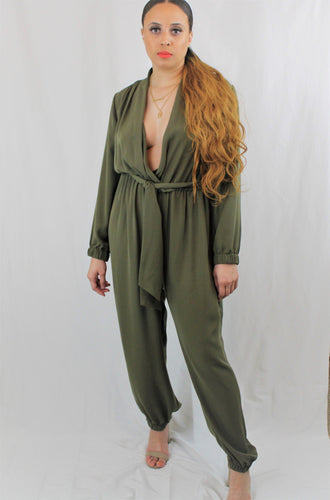 Showstopping jumpsuit with V-neckline, long sleeves, and trendy tie-front bodice. A fitted waist tops dramatic, wide-leg pants with full-length hems